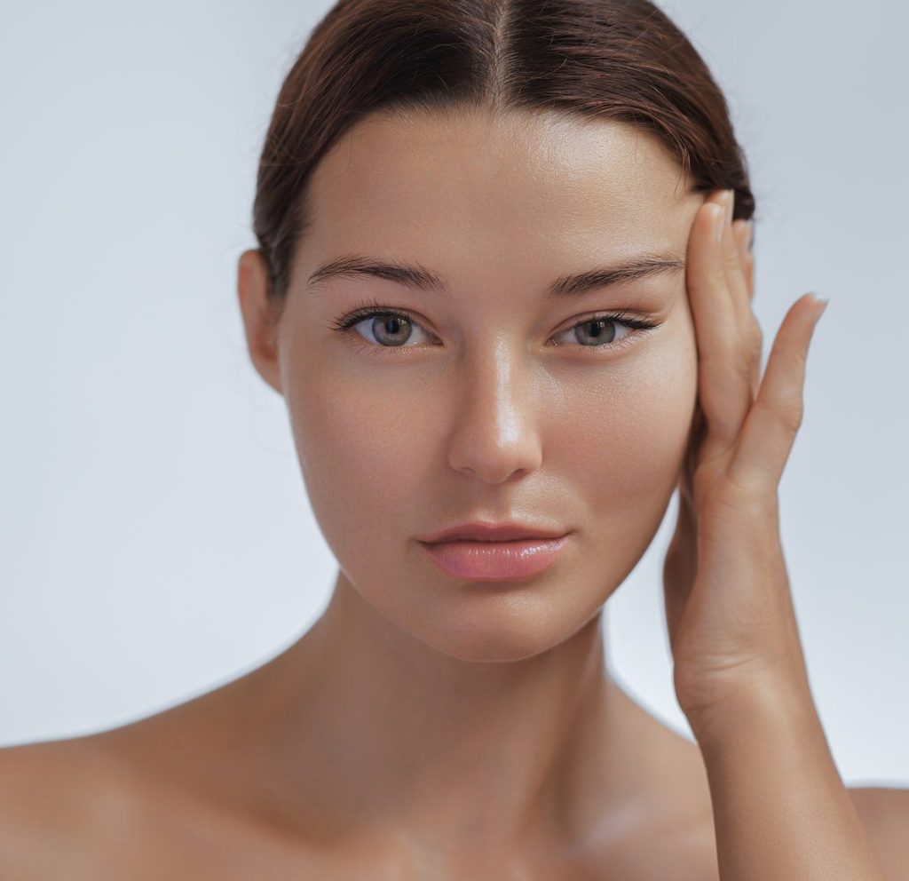 Anti Aging Treatment and Facelift Skin Care Concept. Woman with hand on cheek and eye