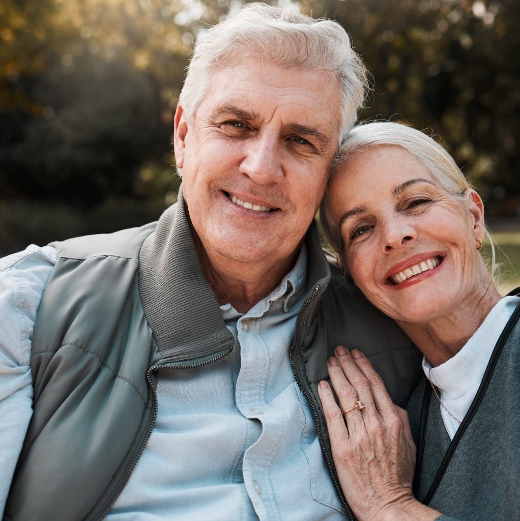 Smile, portrait and senior couple hug in a forest, love and bond in nature on a weekend trip togeth
