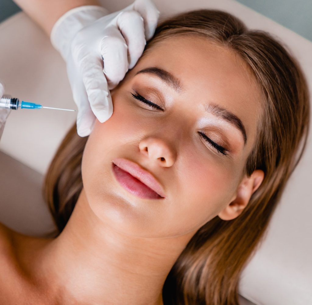 Spa and Cosmetic Young woman gets beauty facial injections in salon